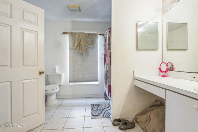 bathroom featuring vanity, baseboards, toilet, tile patterned flooring, and visible vents