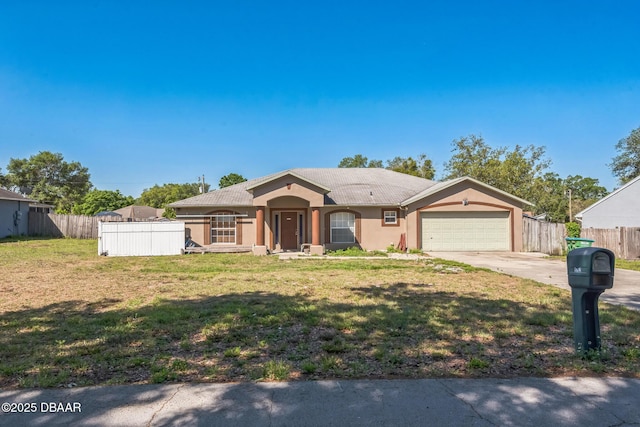ranch-style house with concrete driveway, fence, a garage, a front yard, and stucco siding
