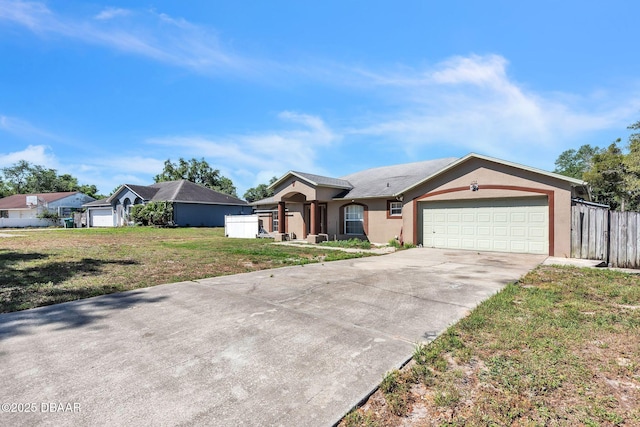single story home featuring concrete driveway, an attached garage, fence, a front yard, and stucco siding
