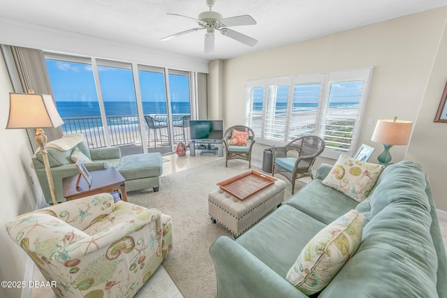 living room with light tile patterned floors and ceiling fan