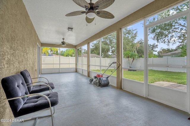 sunroom featuring ceiling fan and a healthy amount of sunlight