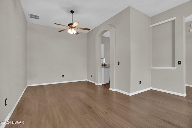 empty room with hardwood / wood-style floors, ceiling fan, and a textured ceiling