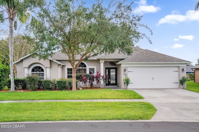 ranch-style house with a garage and a front lawn