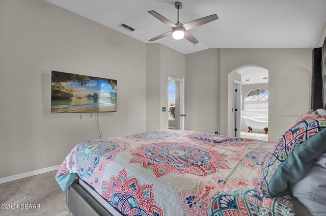 bedroom with a textured ceiling, lofted ceiling, ceiling fan, and concrete floors