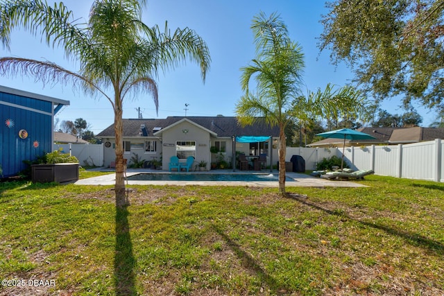 view of yard featuring a pool and a patio