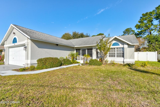 ranch-style house featuring a front yard and a garage