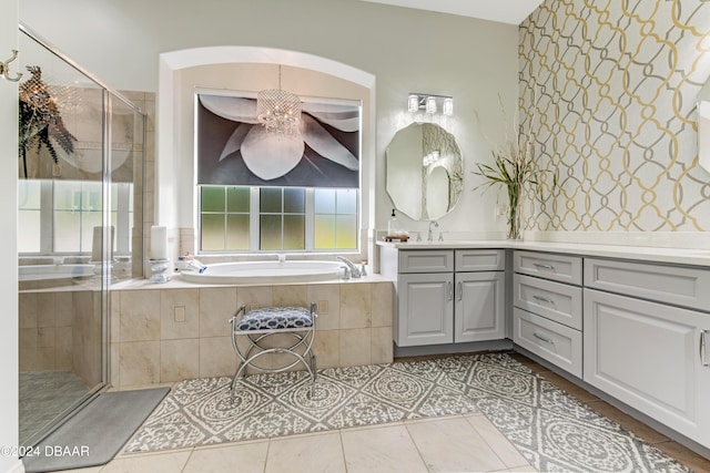 bathroom with a garden tub, a stall shower, vanity, and tile patterned flooring