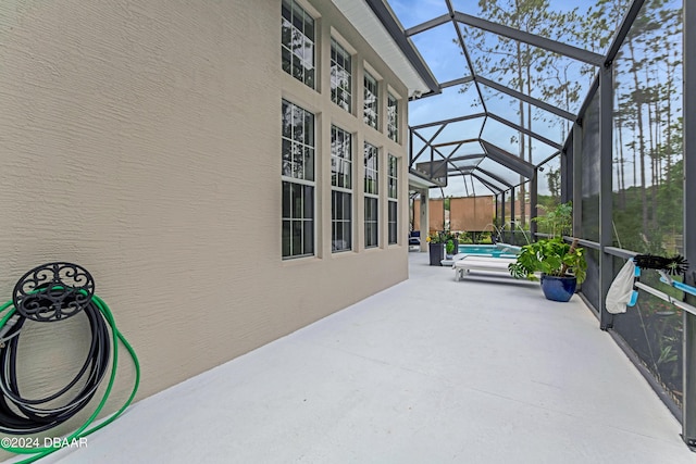 view of patio / terrace with a lanai and an outdoor pool