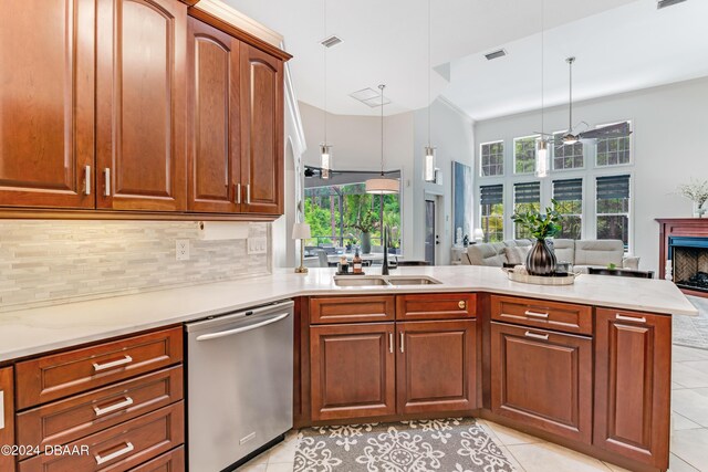 kitchen featuring a breakfast bar, light tile patterned floors, a peninsula, freestanding refrigerator, and arched walkways