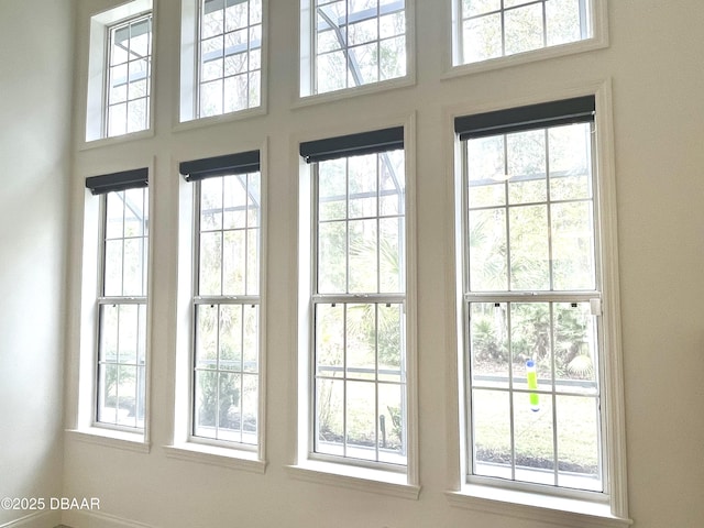 doorway to outside featuring a towering ceiling