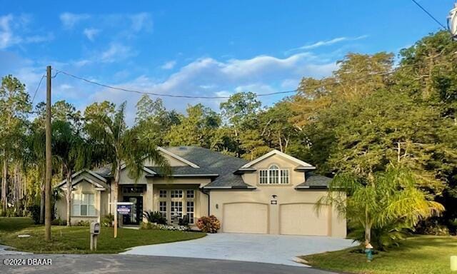 view of front facade featuring a front yard and a garage