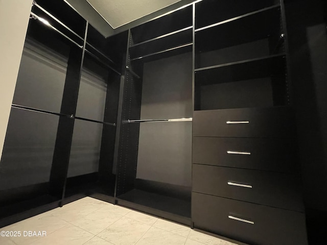 walk in closet featuring tile patterned flooring