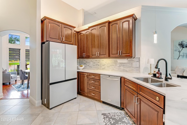 kitchen featuring sink, hanging light fixtures, light tile patterned floors, white refrigerator, and dishwasher