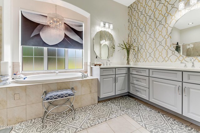 living area with light tile patterned floors, a fireplace, baseboards, and a ceiling fan