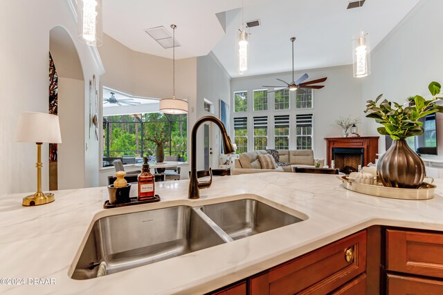 unfurnished sunroom with visible vents and a ceiling fan