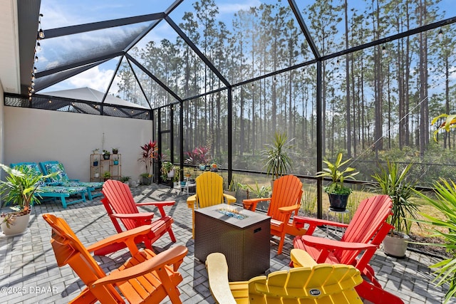 view of patio featuring a lanai and a fire pit