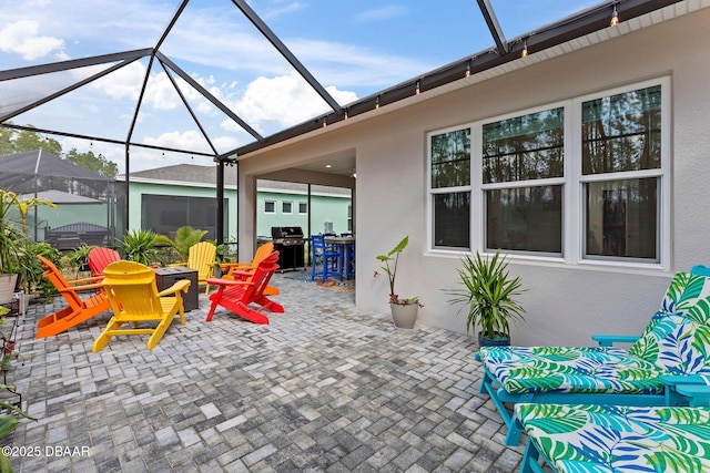 view of patio with grilling area and glass enclosure