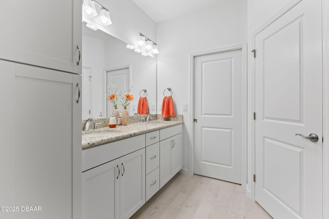 bathroom featuring vanity and hardwood / wood-style floors