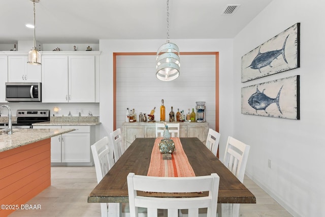 dining area with light hardwood / wood-style flooring