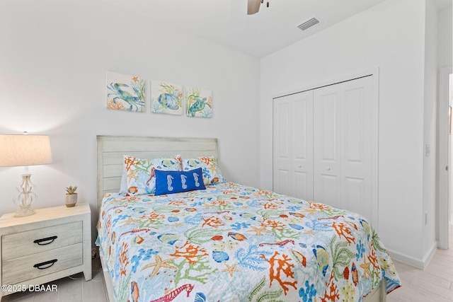 bedroom featuring ceiling fan, a closet, and light hardwood / wood-style flooring