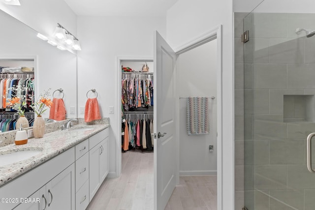 bathroom featuring vanity and an enclosed shower