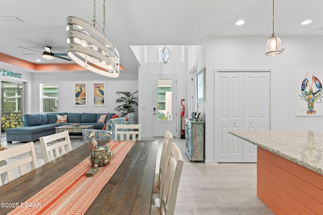 dining space with ceiling fan, light hardwood / wood-style flooring, and a wealth of natural light