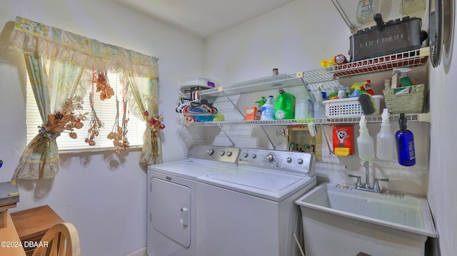 laundry area with separate washer and dryer and sink