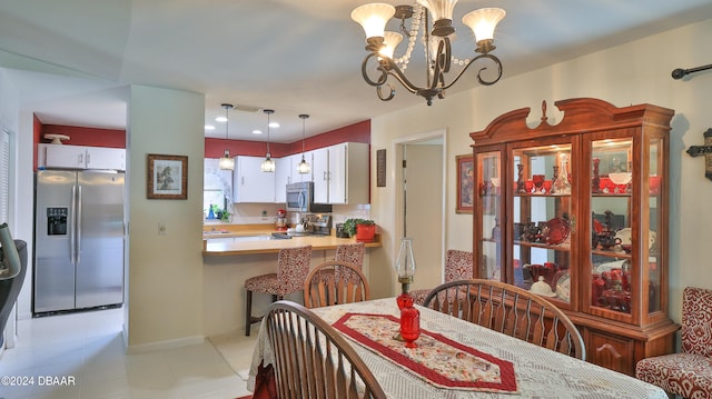 tiled dining area with an inviting chandelier