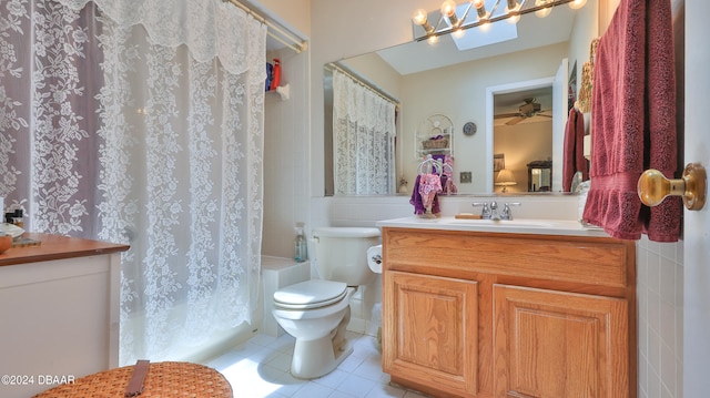 bathroom with toilet, vanity, tile walls, and tile patterned floors