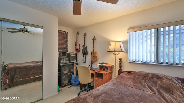 carpeted bedroom with a textured ceiling and ceiling fan