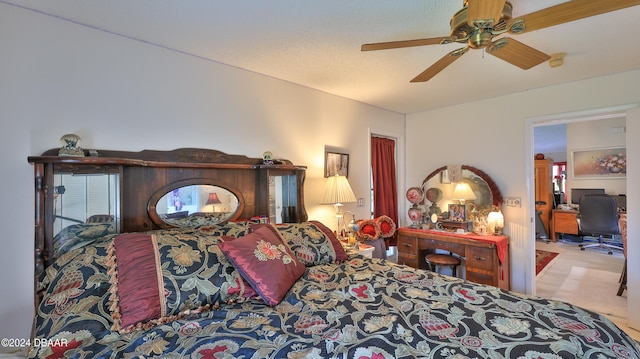 bedroom with a textured ceiling and ceiling fan