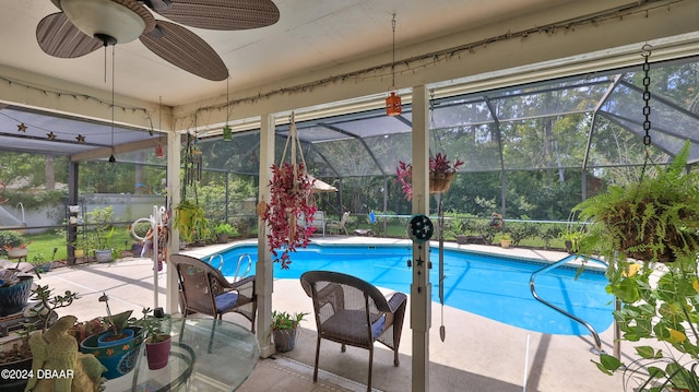 view of swimming pool with a lanai, ceiling fan, and a patio