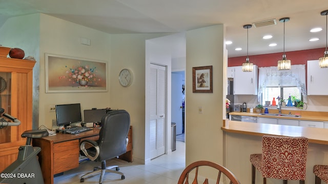 office space with a notable chandelier, sink, and light tile patterned floors