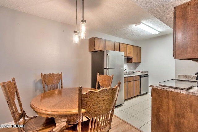 dining room featuring light tile patterned floors and a textured ceiling