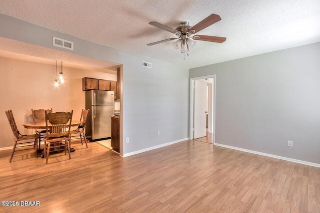 dining room with visible vents, a ceiling fan, and light wood-style floors