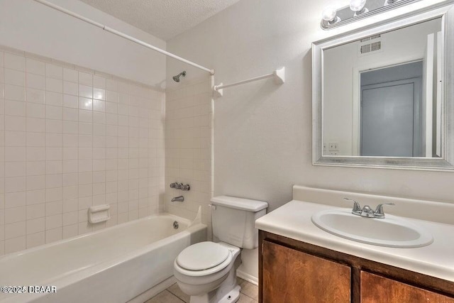 bathroom with visible vents, toilet, bathing tub / shower combination, a textured ceiling, and vanity