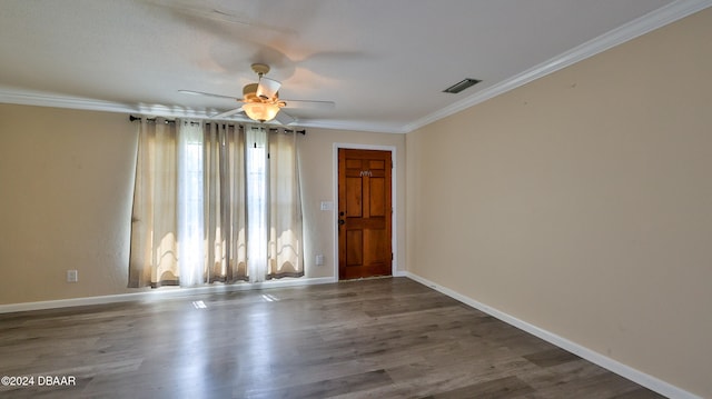 empty room featuring dark hardwood / wood-style flooring, ceiling fan, and crown molding