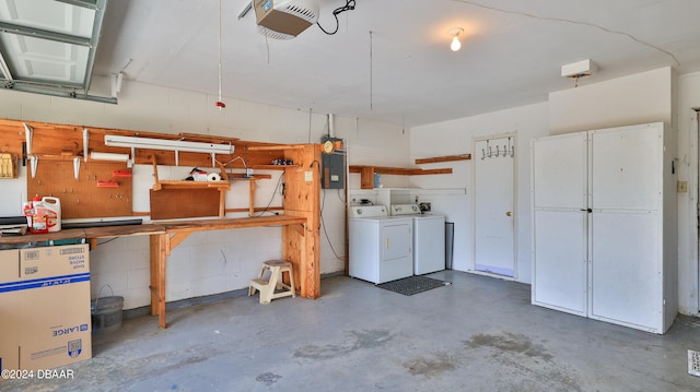 garage with separate washer and dryer and a garage door opener