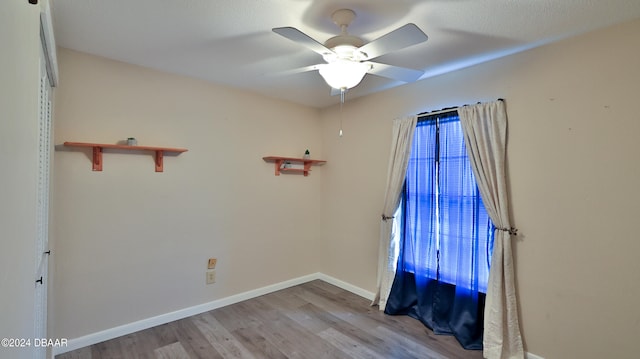 unfurnished room featuring light hardwood / wood-style flooring and ceiling fan