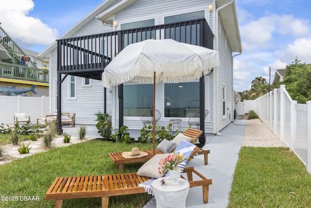 rear view of property with a yard and a patio