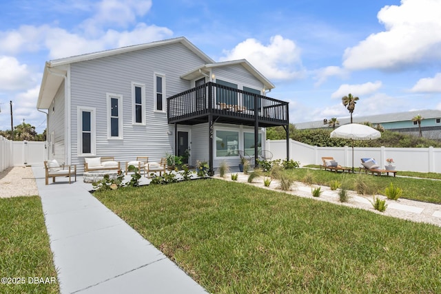 back of property with a patio, a yard, and a deck