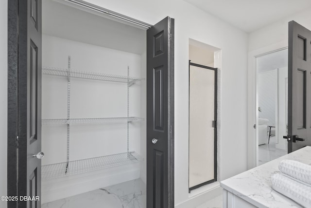 bathroom with vanity and a shower with door