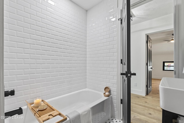 bathroom with hardwood / wood-style flooring, sink, and ceiling fan