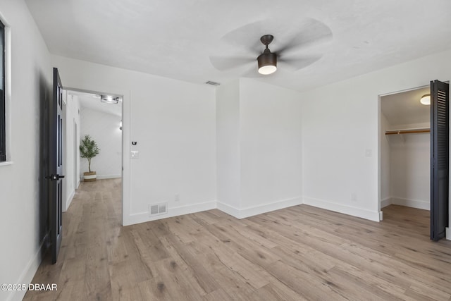 unfurnished bedroom featuring a closet, ceiling fan, and light hardwood / wood-style flooring