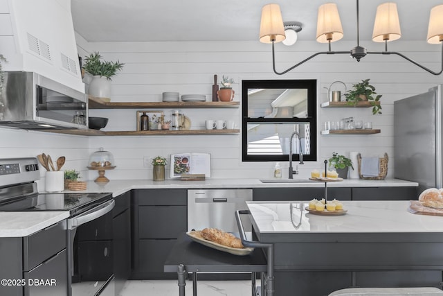 kitchen featuring hanging light fixtures, decorative backsplash, sink, and appliances with stainless steel finishes