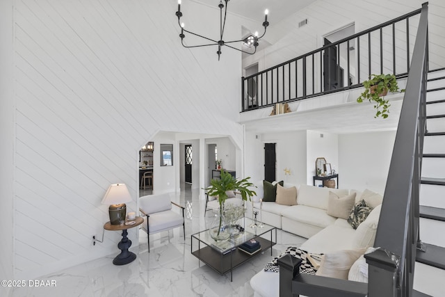 living room featuring a notable chandelier and a towering ceiling