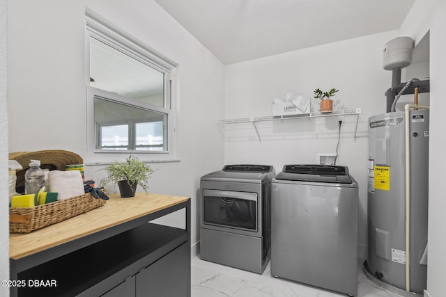 clothes washing area with electric water heater and washer and dryer