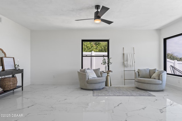 living area with ceiling fan