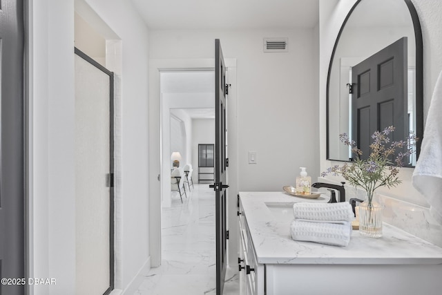 bathroom featuring vanity and a shower with shower door