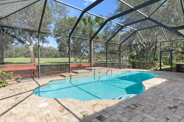 view of pool with a patio and a lanai